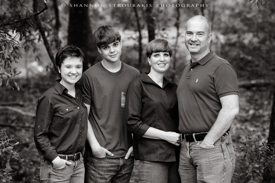 black and white photographer in the woodlands with a family outdoors
