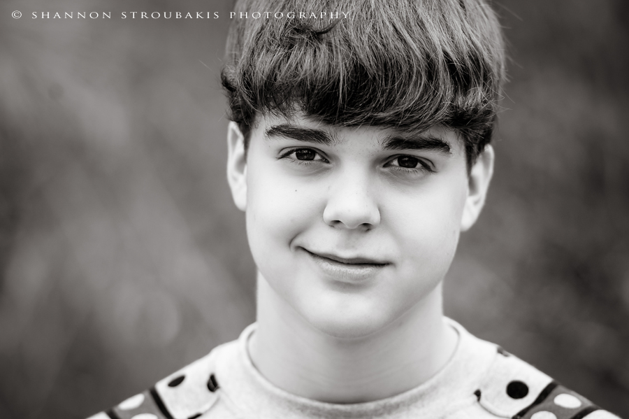 black and white portrait of a teen boy in the woodlands 