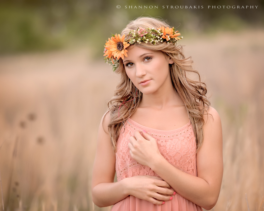 beautiful senior portraits in spring tx in a field with a floral crown